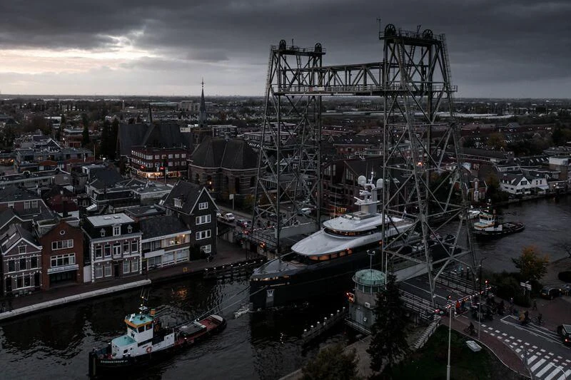 a large ship docked in a harbor aboard SHINKAI Yacht for Sale