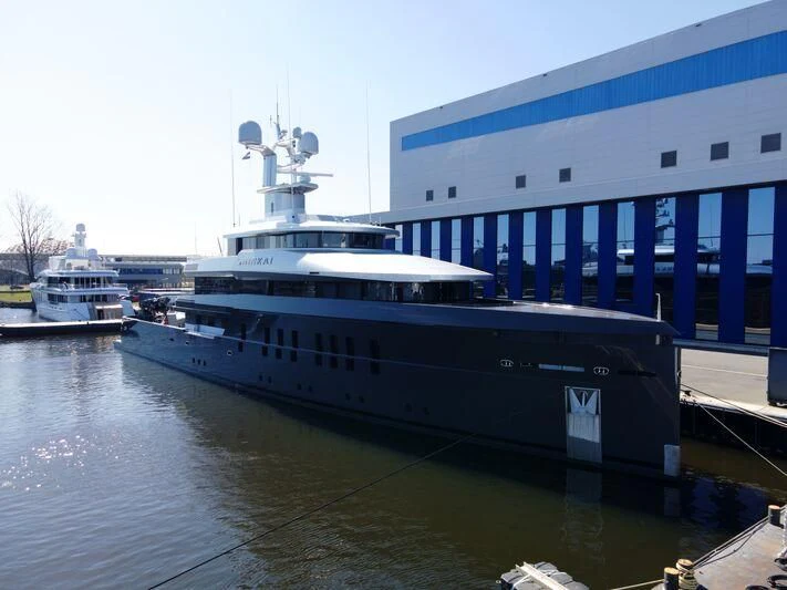 a large boat docked at a pier aboard SHINKAI Yacht for Sale