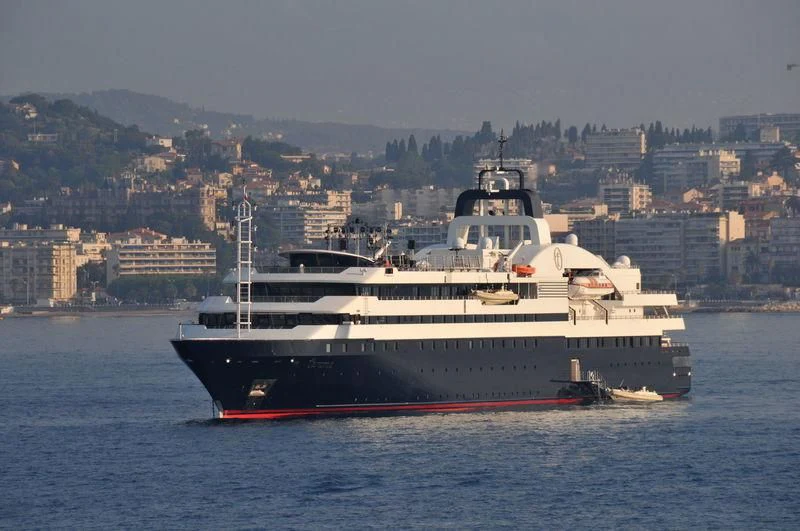 a large white boat in the water aboard TURAMA Yacht for Sale