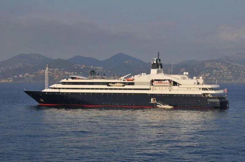a large ship in the water aboard TURAMA Yacht for Sale