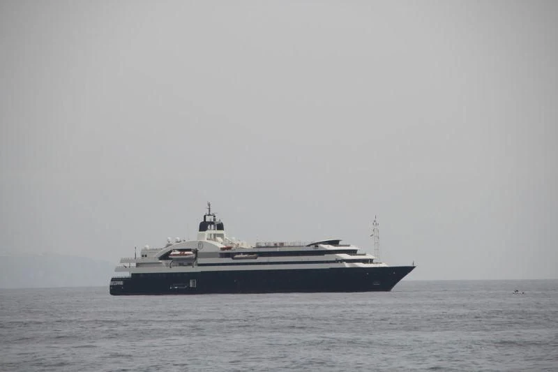 a large ship in the water aboard TURAMA Yacht for Sale