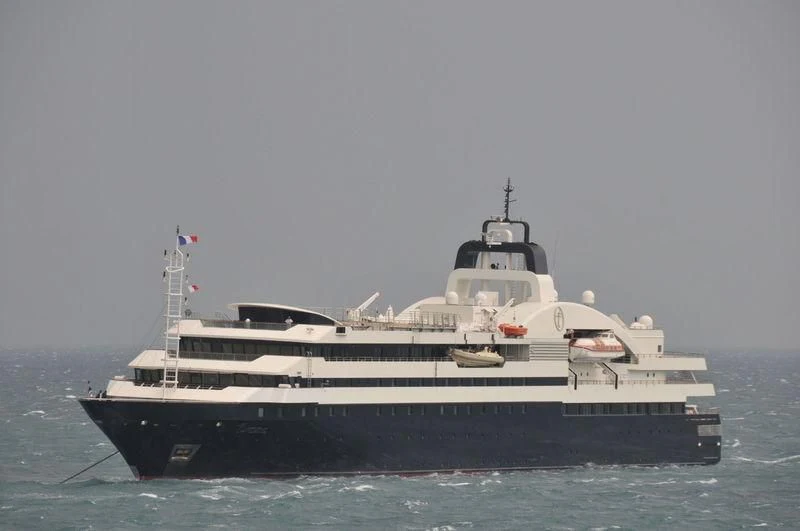 a large ship in the water aboard TURAMA Yacht for Sale