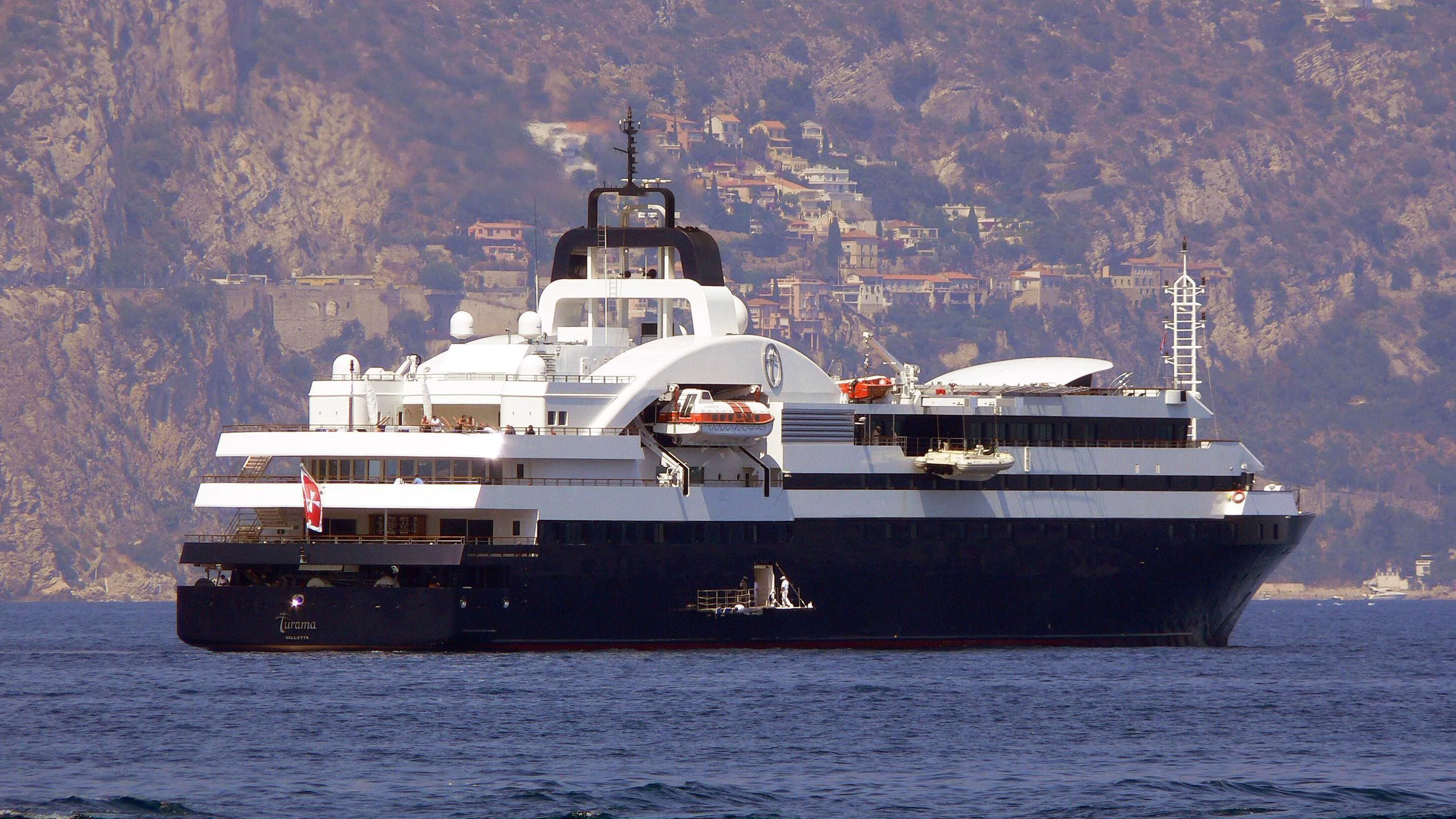 a large ship in the water aboard TURAMA Yacht for Sale