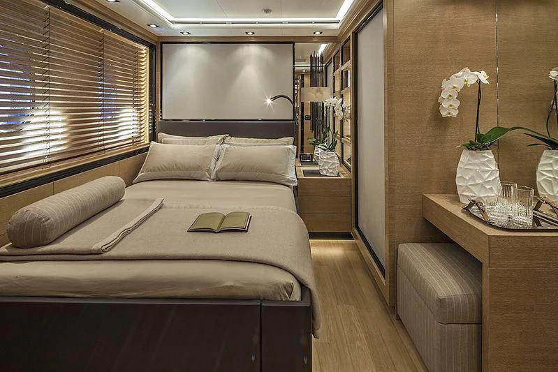 a bedroom with a bed and a desk aboard ALASKA Yacht for Sale