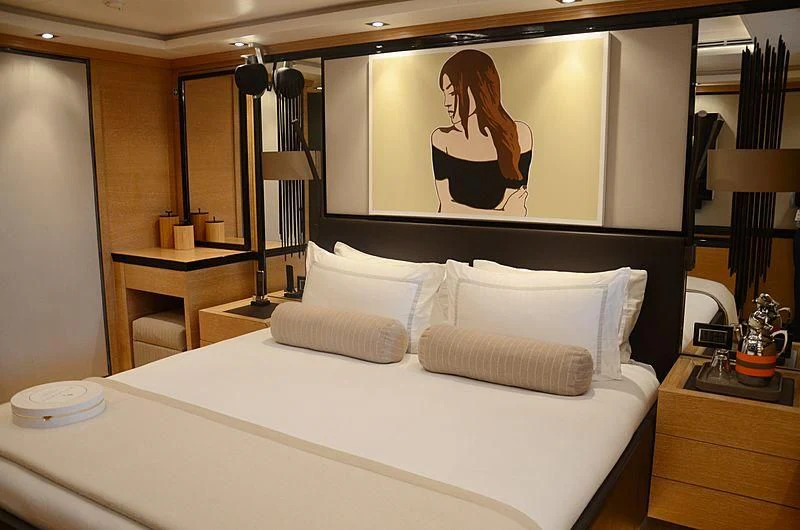 a bed with a large mirror above it aboard ALASKA Yacht for Sale