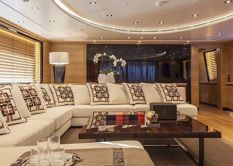 a living room with a large sofa aboard ALASKA Yacht for Sale