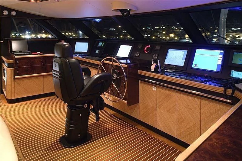 a black chair in a room with a computer and a desk with a large screen and a large aboard ALASKA Yacht for Sale
