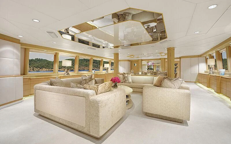 a living room with a large white couch and a large mirror aboard AZZURRA II Yacht for Sale