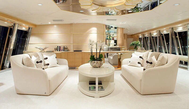 a room with a table and couches aboard AZZURRA II Yacht for Sale