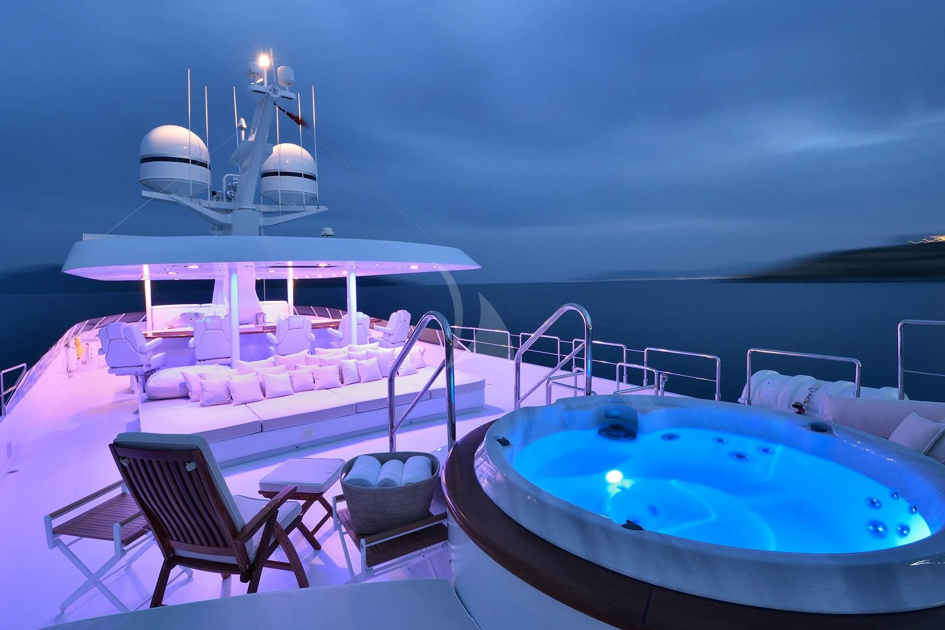 a swimming pool with a table and chairs on a deck with a large white and blue pool in aboard AZZURRA II Yacht for Sale