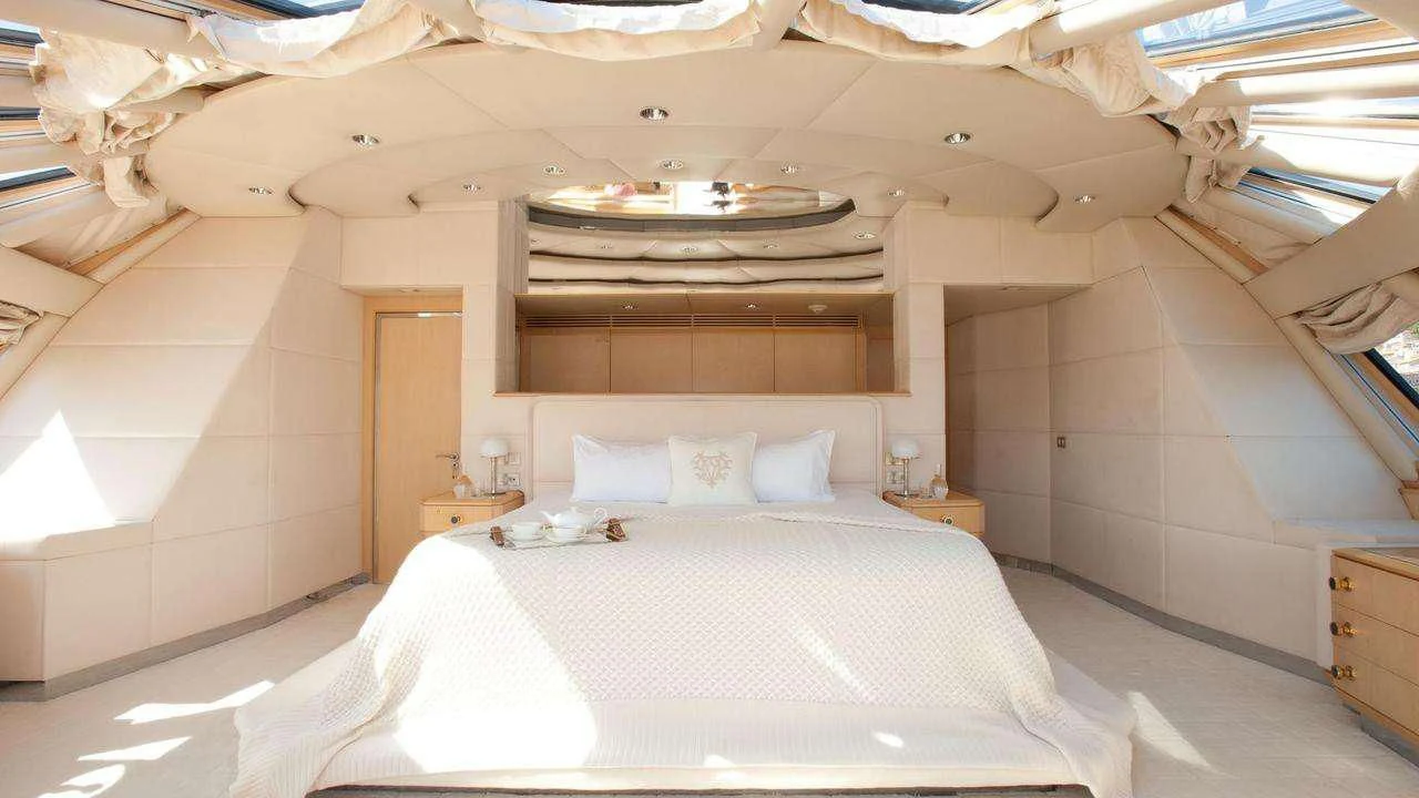 a room with a bed and a dresser aboard AZZURRA II Yacht for Sale