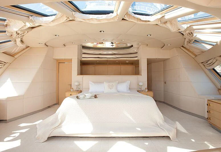 a large bed with a white sheet aboard AZZURRA II Yacht for Sale