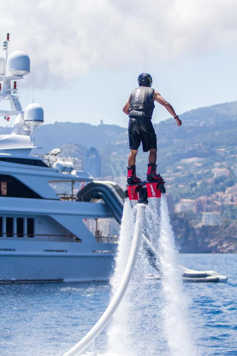 a man standing on a ladder aboard AIR Yacht for Sale