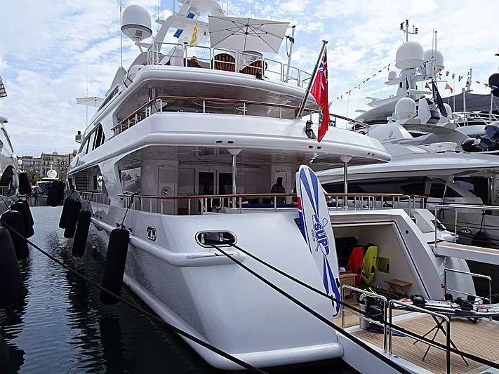 a large white boat with flags on it aboard AIR Yacht for Sale