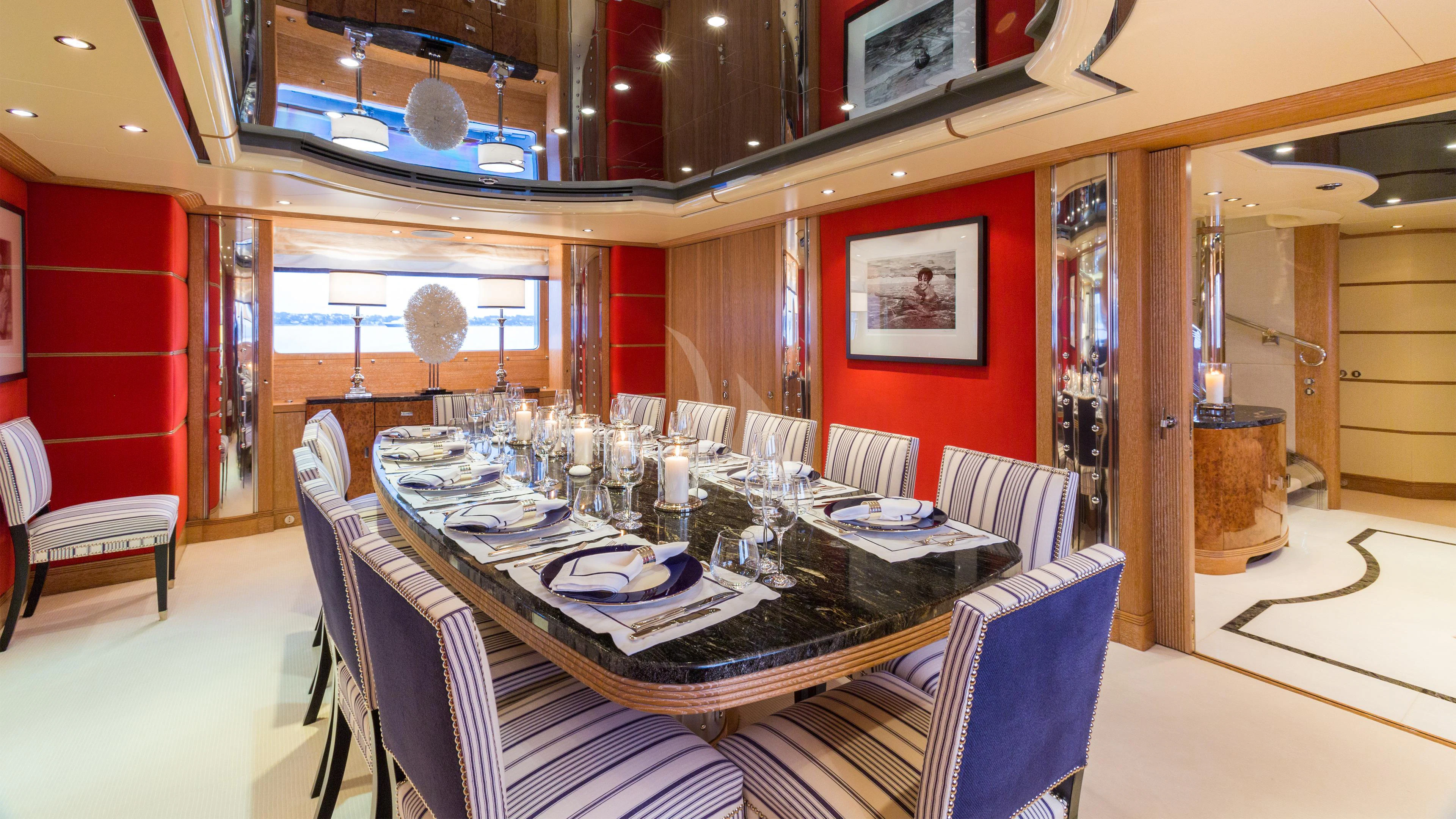 a dining room with a table set aboard AIR Yacht for Sale