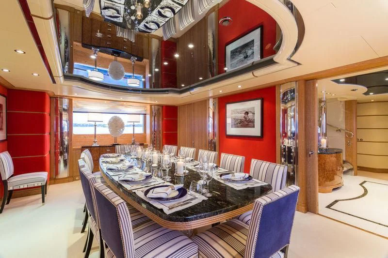 a dining room with a table aboard AIR Yacht for Sale