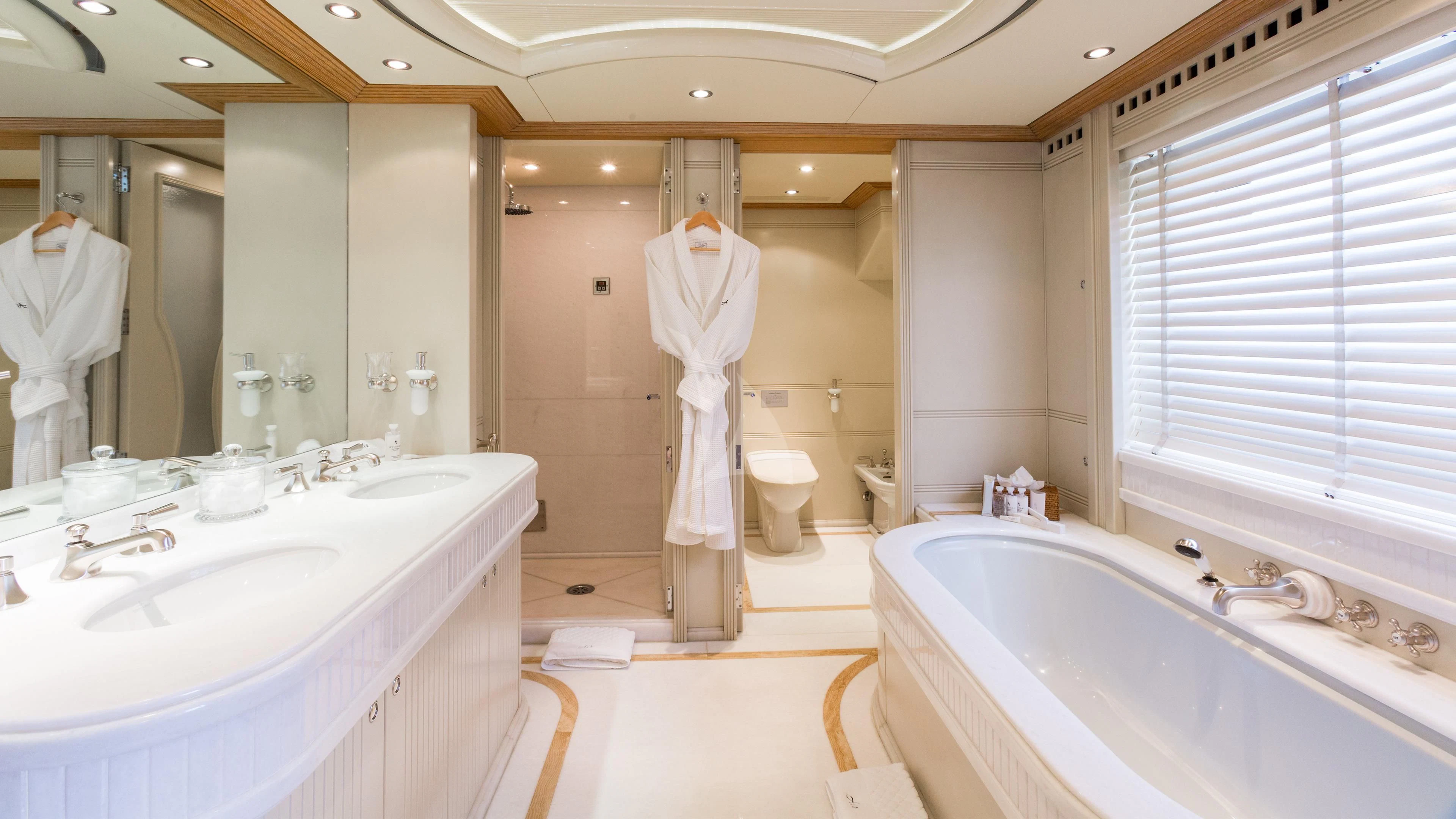 a bathroom with a robe on the wall aboard AIR Yacht for Sale