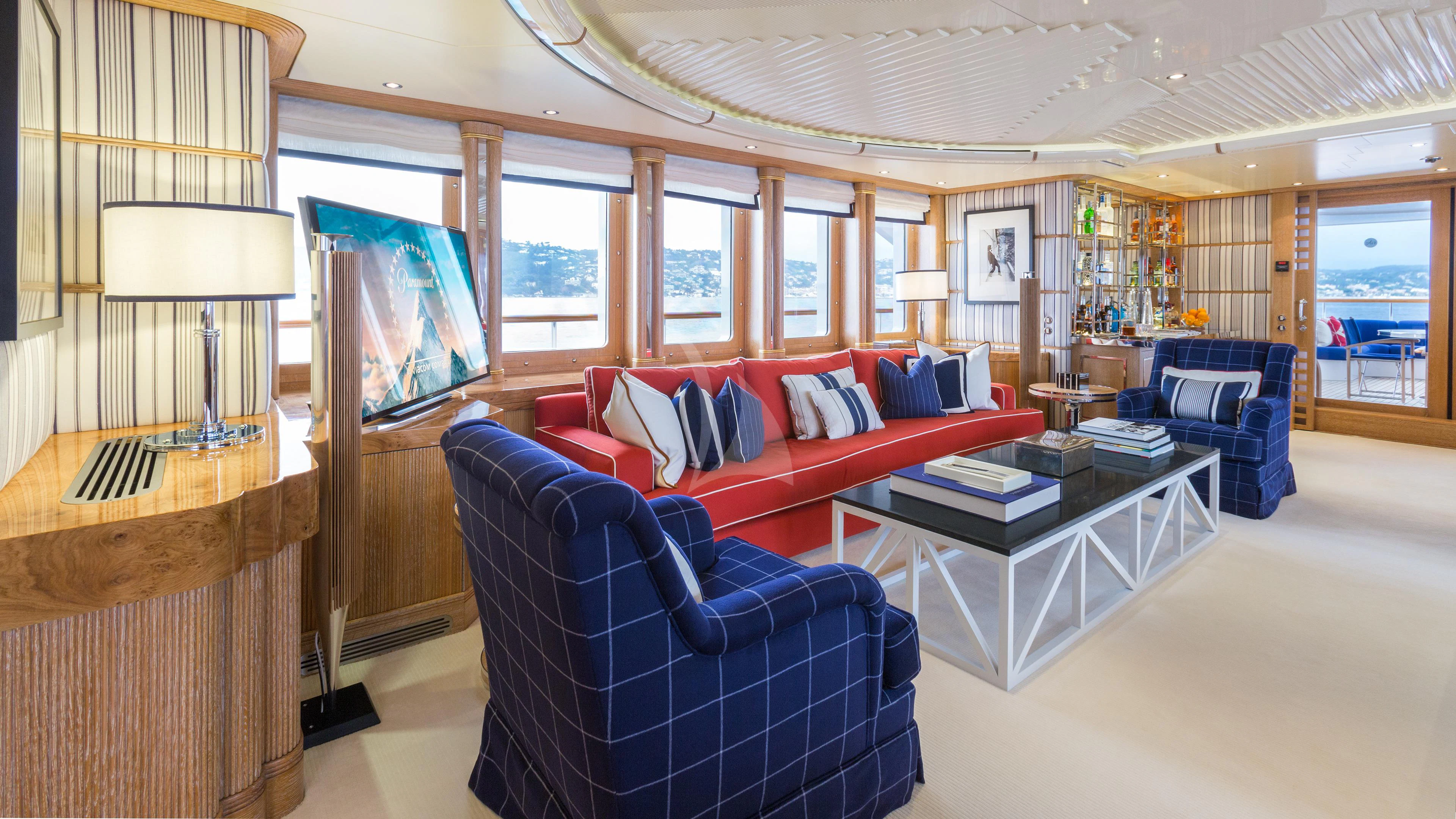 a living room with a blue couch aboard AIR Yacht for Sale