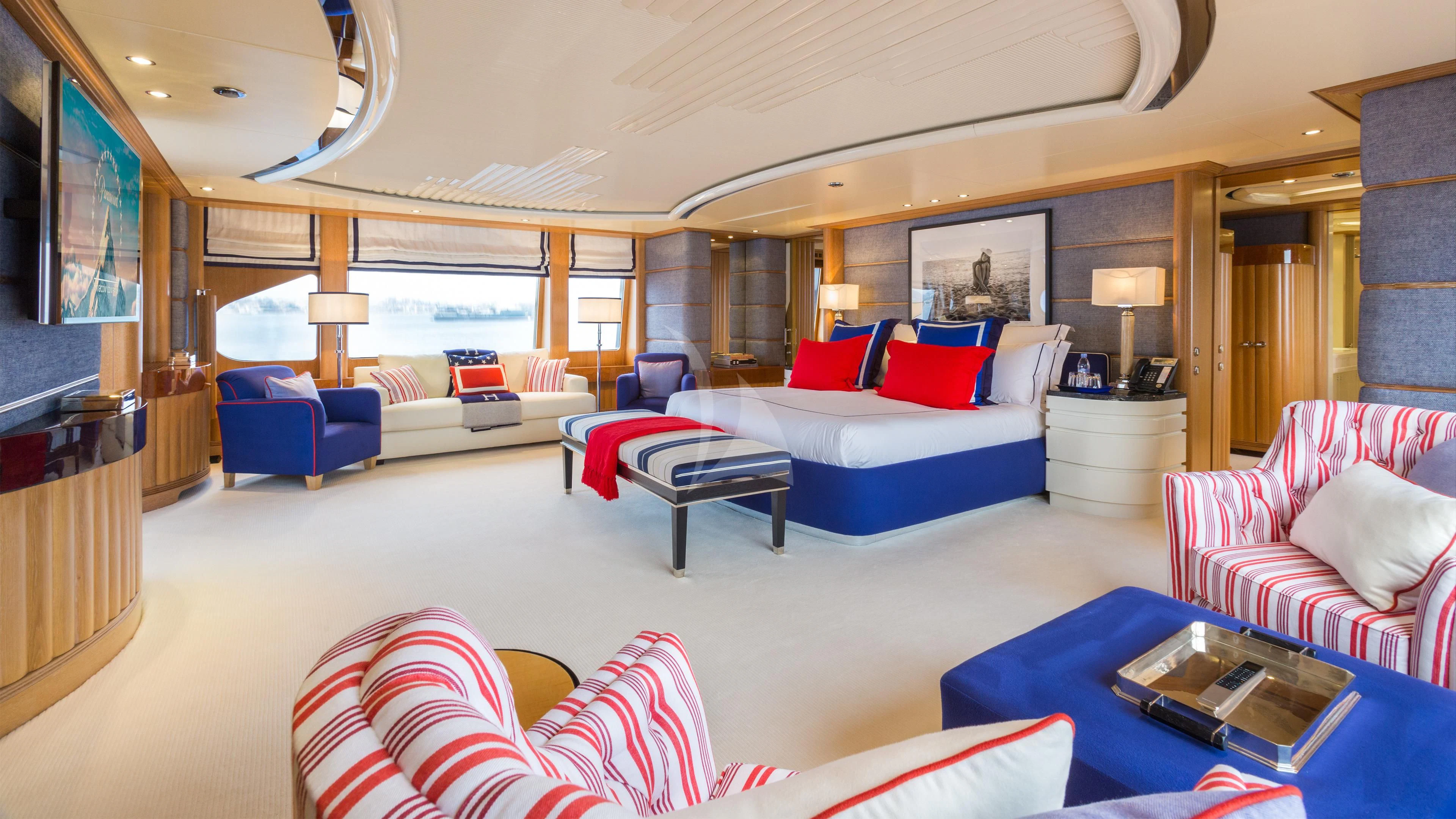 a large living room with a large screen aboard AIR Yacht for Sale