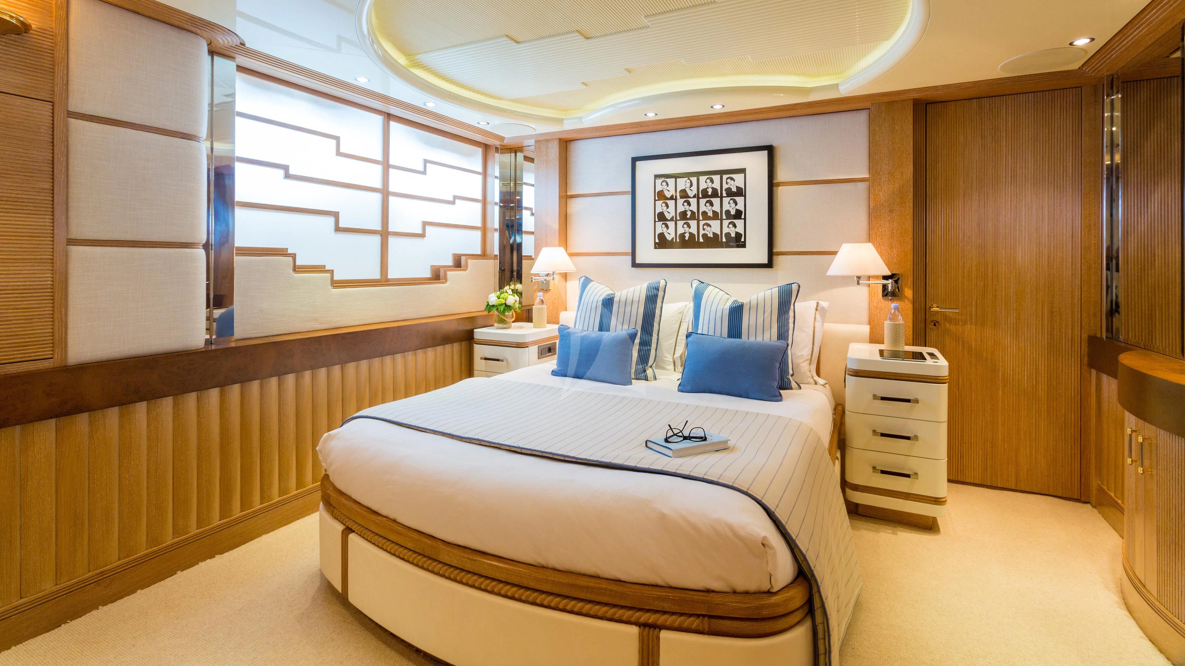 a room with a bed and a desk aboard AIR Yacht for Sale