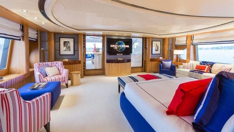 a large room with a bed and a television aboard AIR Yacht for Sale