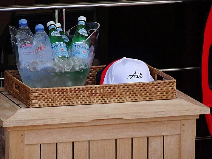 a group of bottles and cans on a wooden table aboard AIR Yacht for Sale