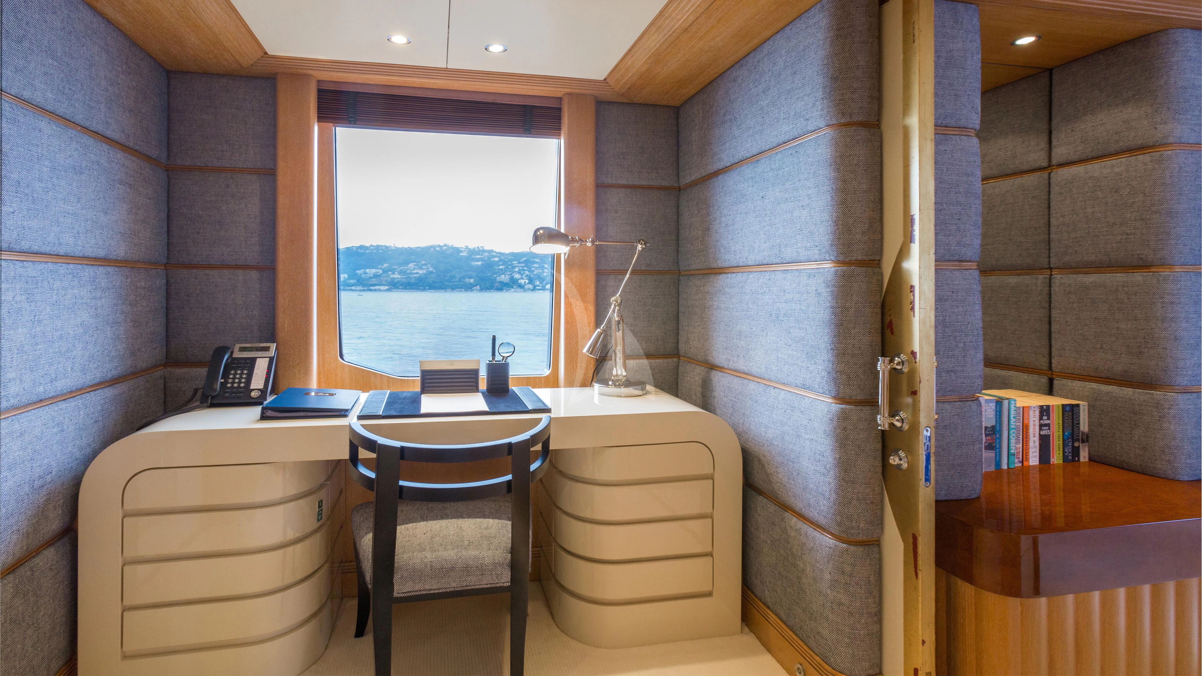 a room with a table and chairs aboard AIR Yacht for Sale