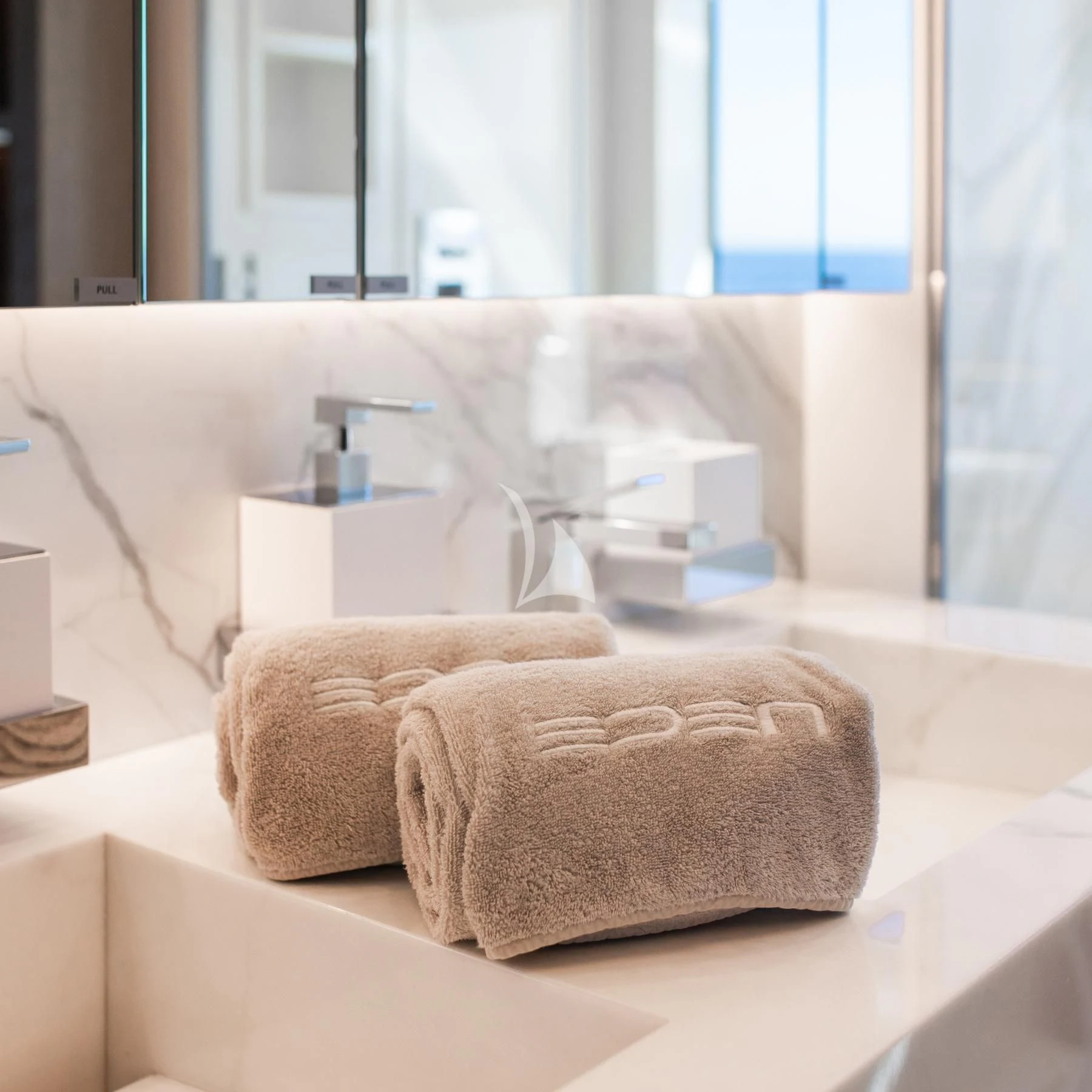 a white sofa with a white coffee table and a white coffee cup on it aboard EDEN Yacht for Sale