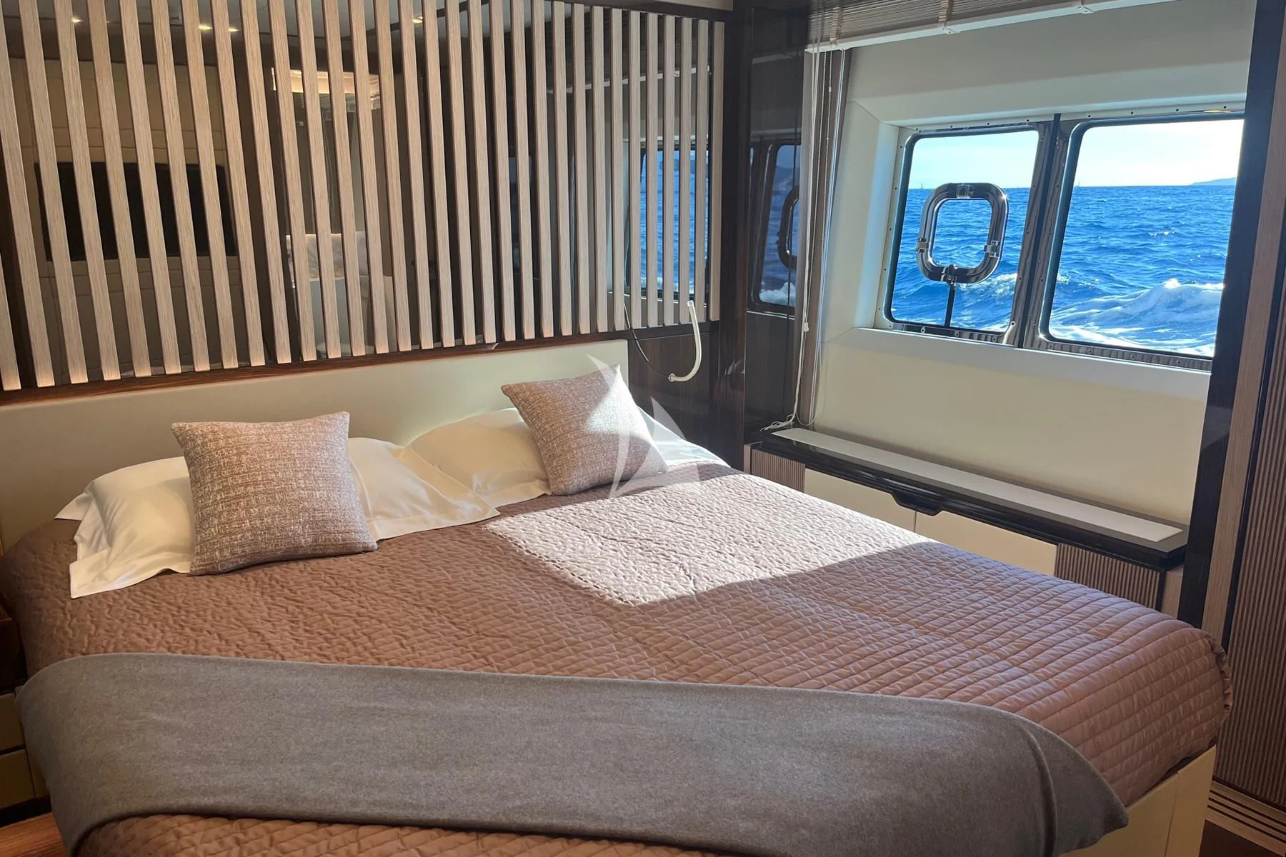 a bed with a large window aboard EDEN Yacht for Sale