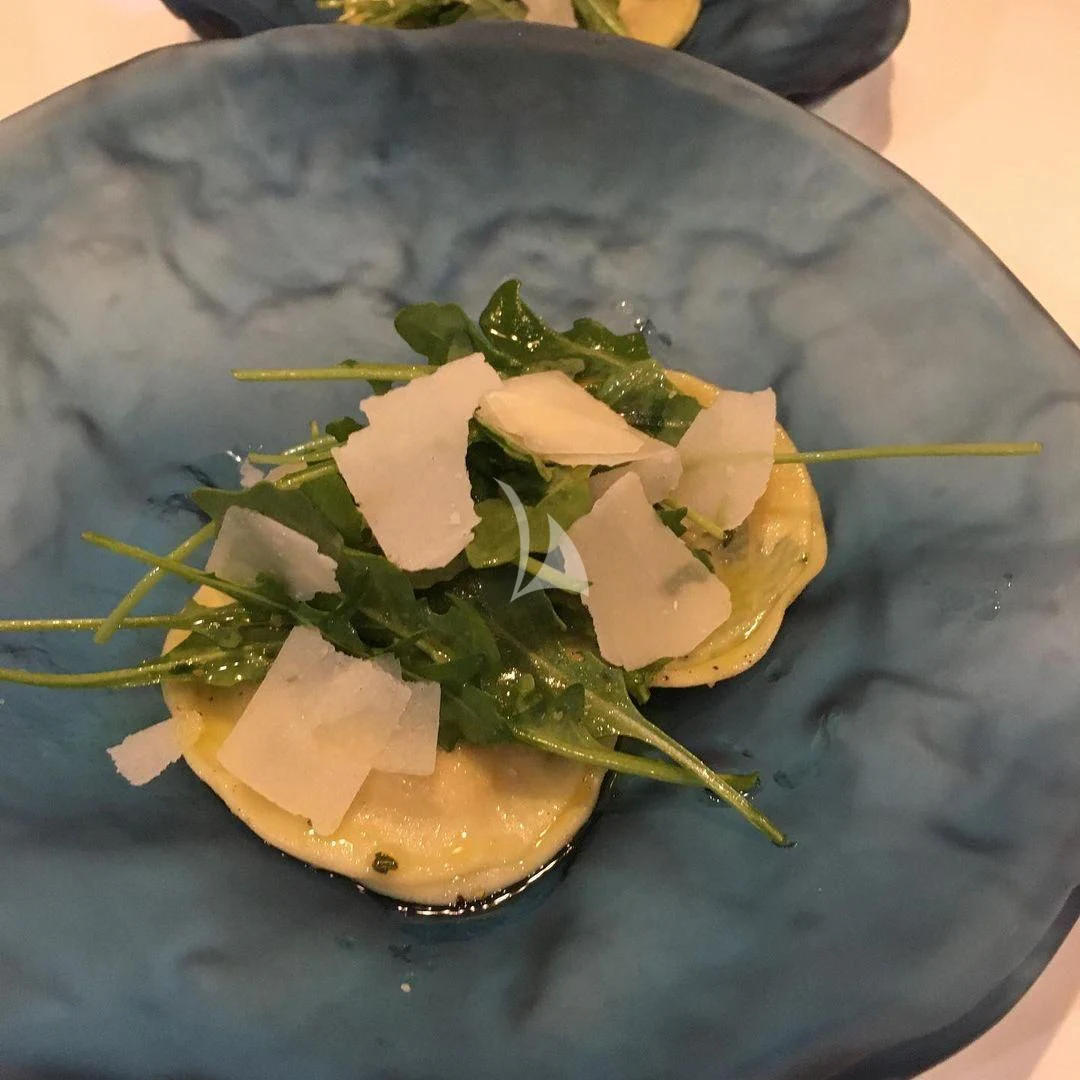 a plate of food aboard EDEN Yacht for Sale