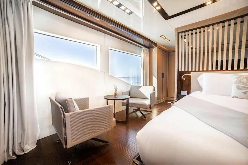 a room with a bed and a table aboard EDEN Yacht for Sale