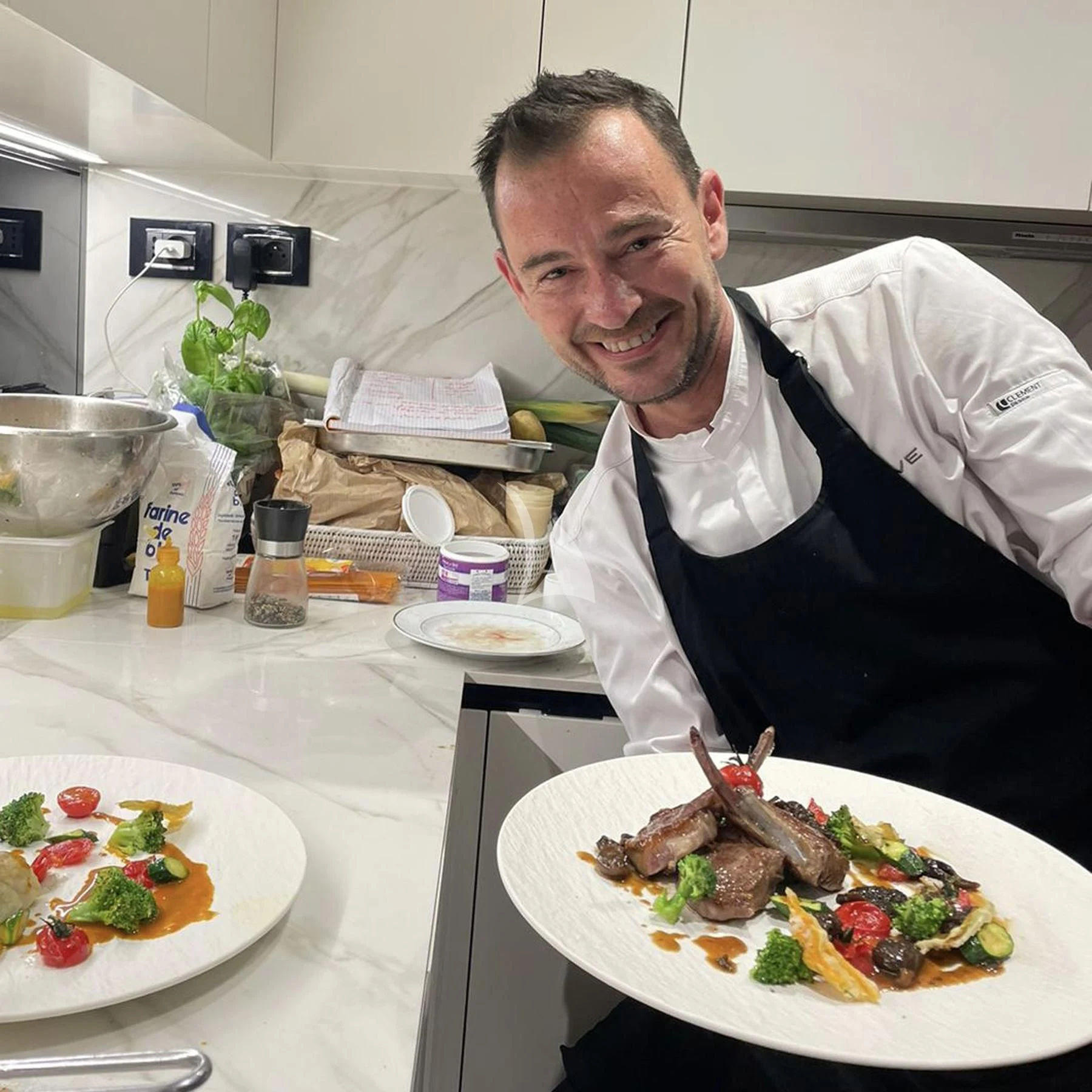 a person sitting at a table with food on it aboard EDEN Yacht for Sale