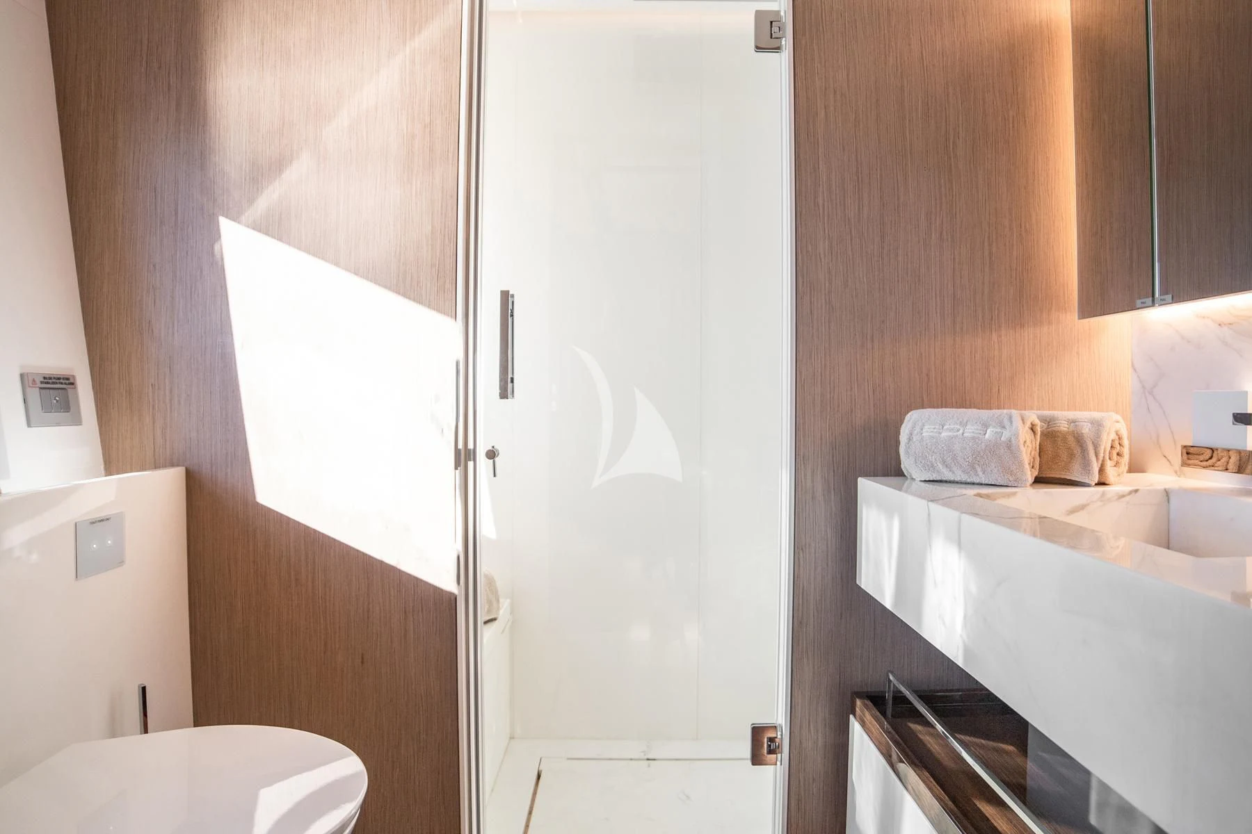 a bathroom with a white door aboard EDEN Yacht for Sale