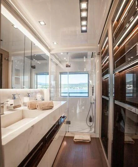 a bathroom with a tub sink and a shower unit aboard EDEN Yacht for Sale