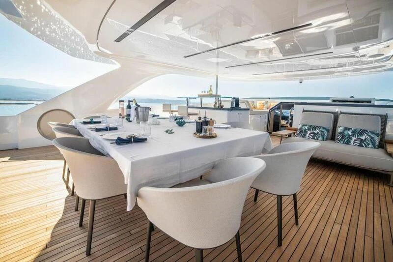 a room with a table and chairs aboard EDEN Yacht for Sale