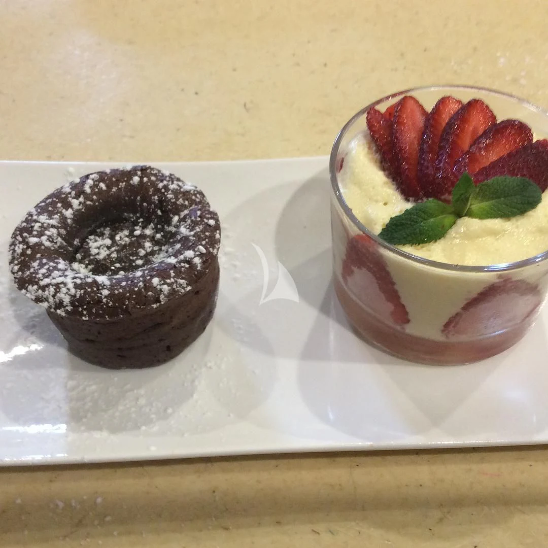 a cup of dessert next to a bowl of ice cream aboard EDEN Yacht for Sale