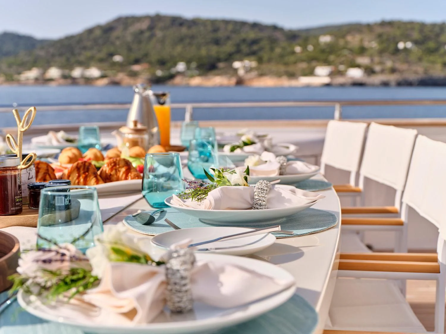 a table with plates and glasses on it aboard ANASA Yacht for Sale