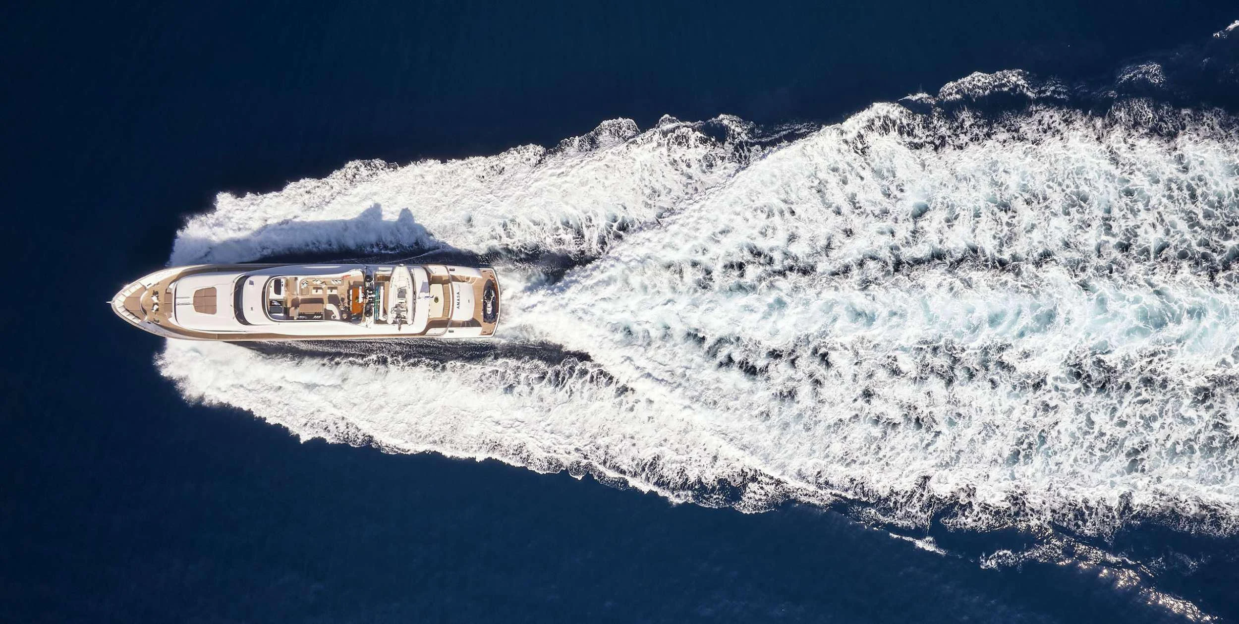 a silver car on a snowy mountain aboard ANASA Yacht for Sale