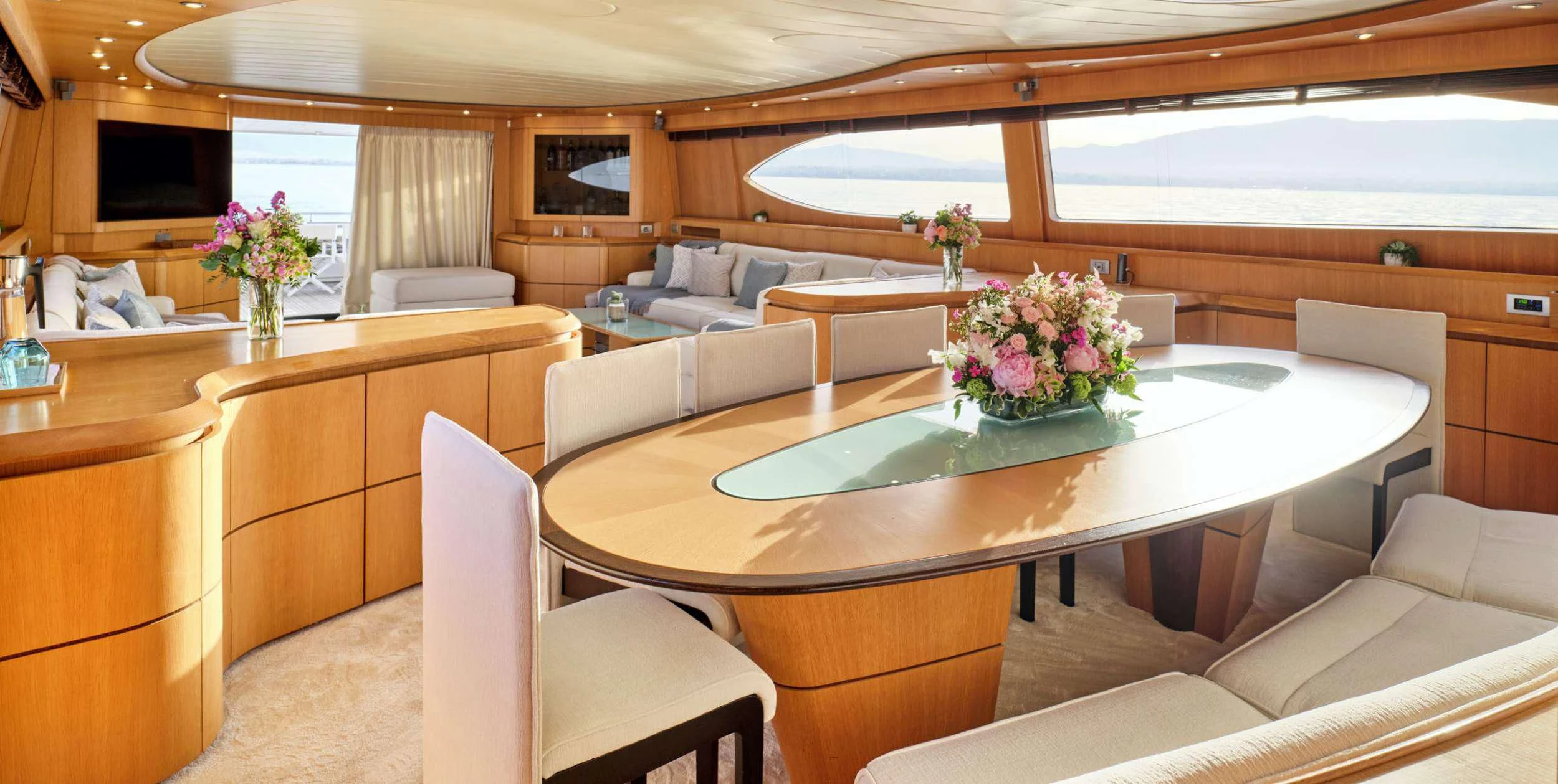 a large living room with a table and chairs aboard ANASA Yacht for Sale