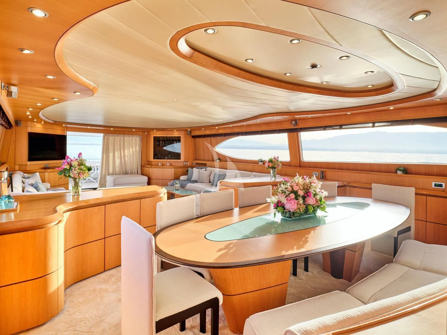 a large living room with a table and chairs aboard ANASA Yacht for Sale