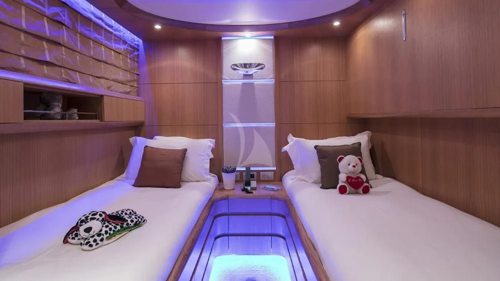 a room with a couple beds aboard ANASA Yacht for Sale