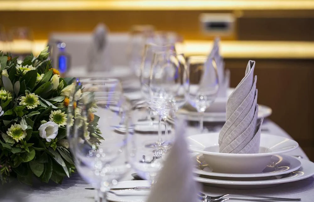 a table with a plate of food and glasses on it aboard ANASA Yacht for Sale