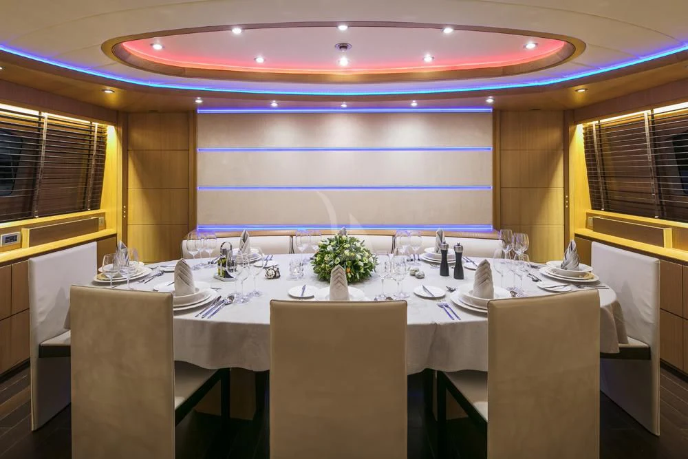 a large room with tables and chairs aboard ANASA Yacht for Sale