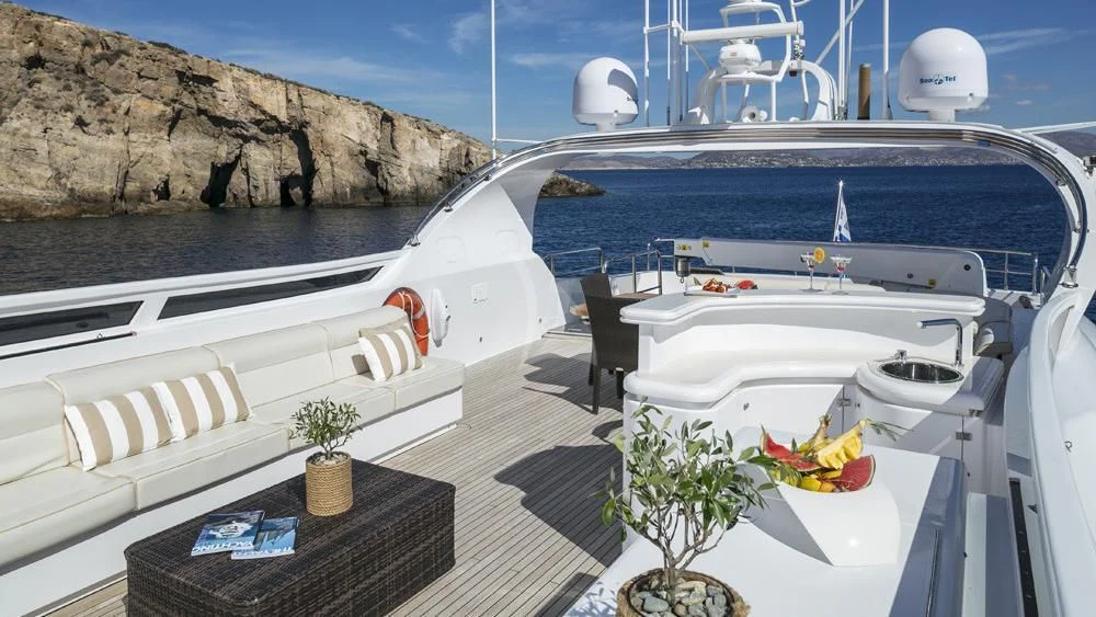 a white boat with plants on the deck aboard ANASA Yacht for Sale