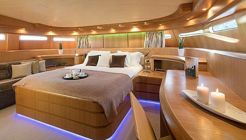 a large room with a bed and a couch aboard ANASA Yacht for Sale