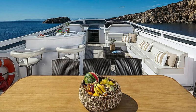 a table with chairs and a basket on it aboard ANASA Yacht for Sale