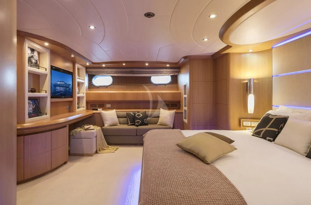 a room with a bed and a couch aboard ANASA Yacht for Sale