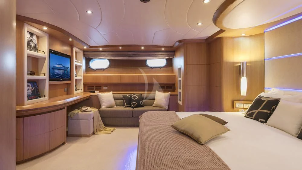 a room with a bed and a television aboard ANASA Yacht for Sale