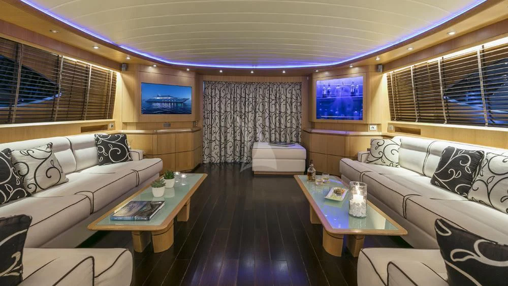 a room with a couch and a table and a television aboard ANASA Yacht for Sale