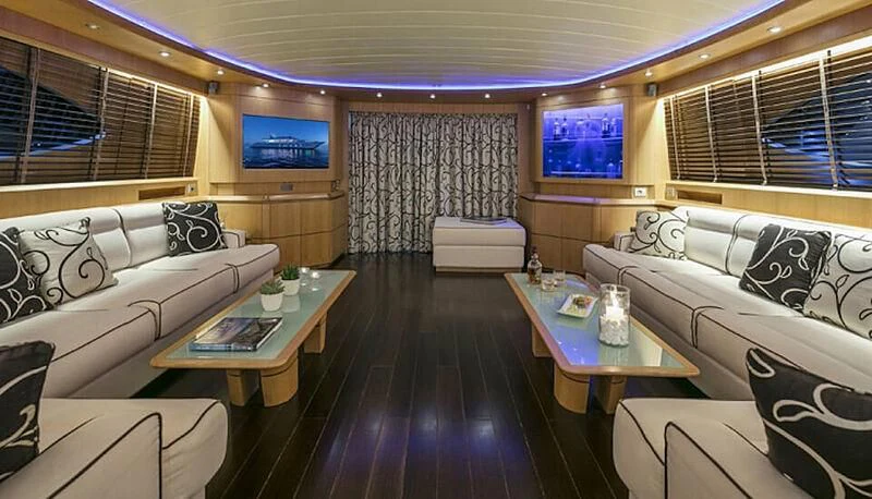 a room with a couch and a table and a television aboard ANASA Yacht for Sale